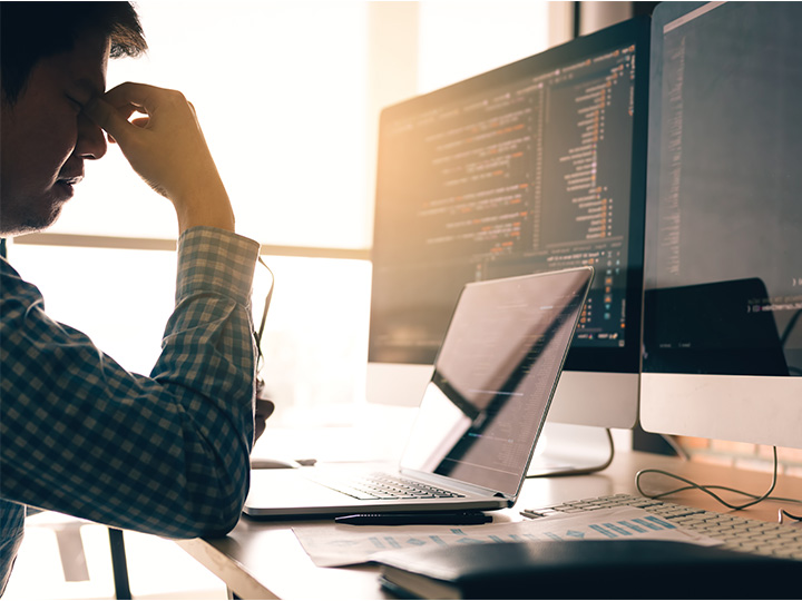 A picture showing a man stressed at work