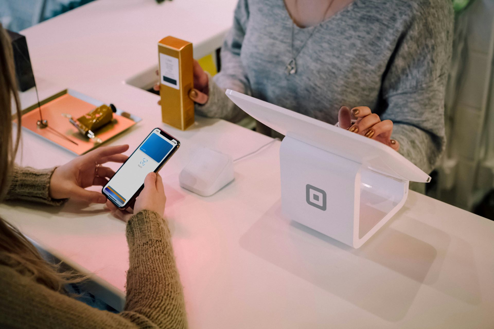 An iPhone with Apple Pay open tries to pay at an NFC payment terminal